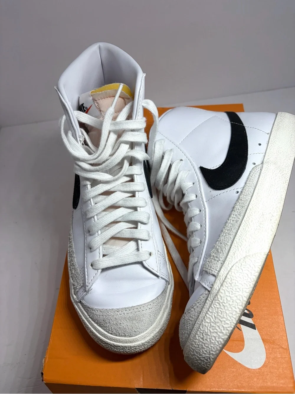 Nike unisex White High-Top Sneakers with Black Swoosh and Yellow Tongue Tab